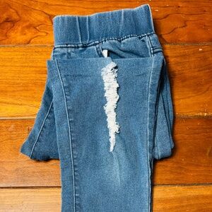 Woman’s ripped jeans